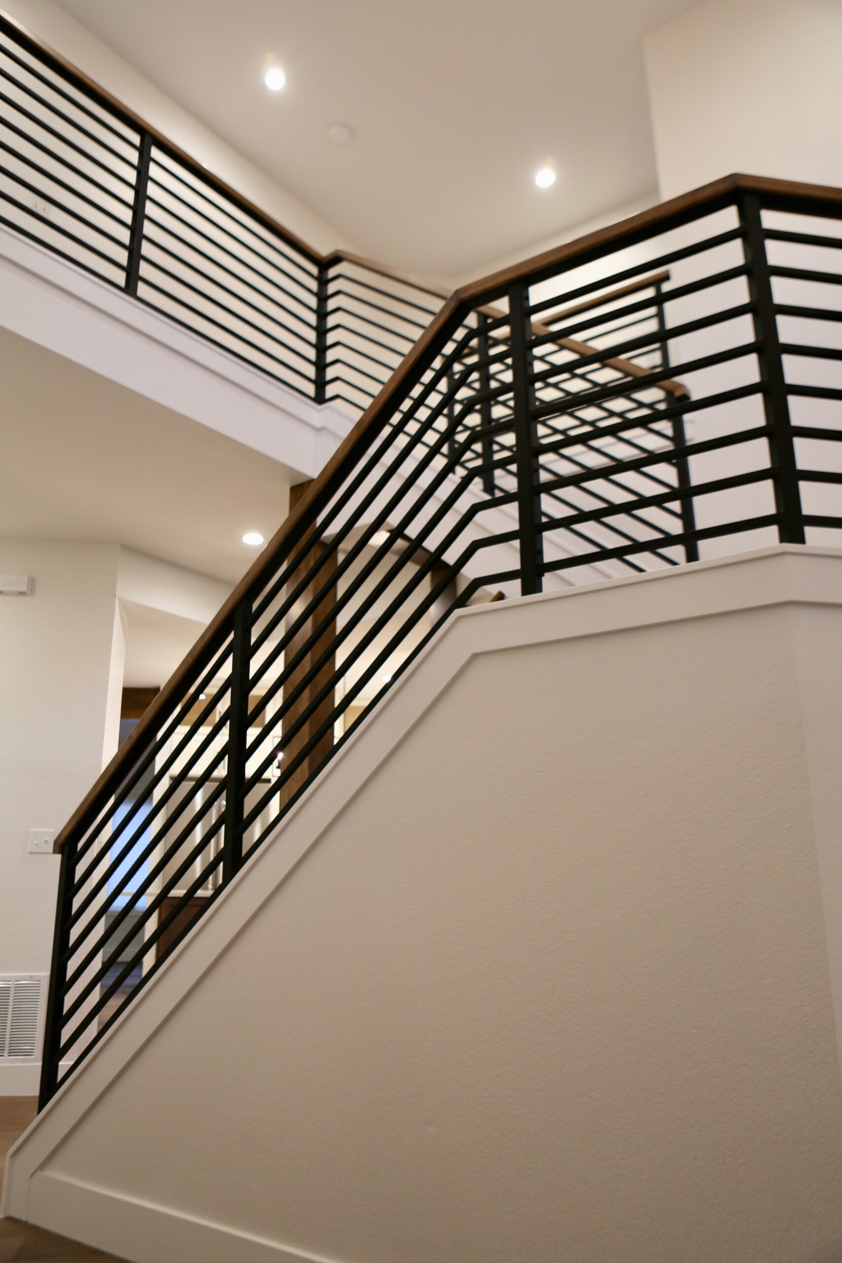 Upper floor landing with modern stair railing design
